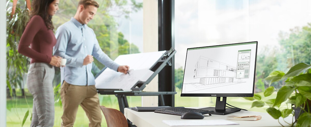 Le persone apprezzano il posto di lavoro con i monitor verdi a basso impatto di Philips.