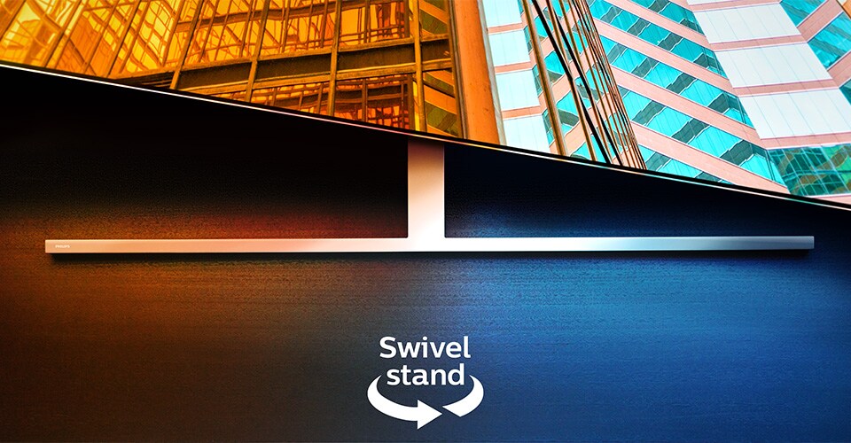 Un televisore Philips Ambilight su un supporto girevole che mostra due scene architettoniche colorate, con una freccia e un testo che indicano la funzione di rotazione