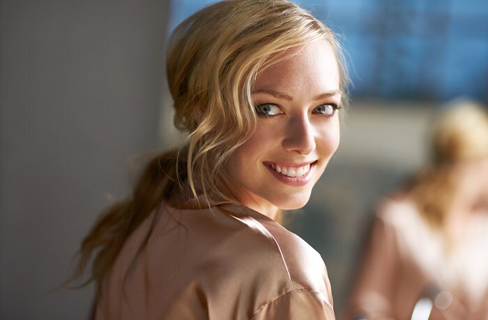 Una ragazza con un ampio sorriso mostra i denti bianco perla.