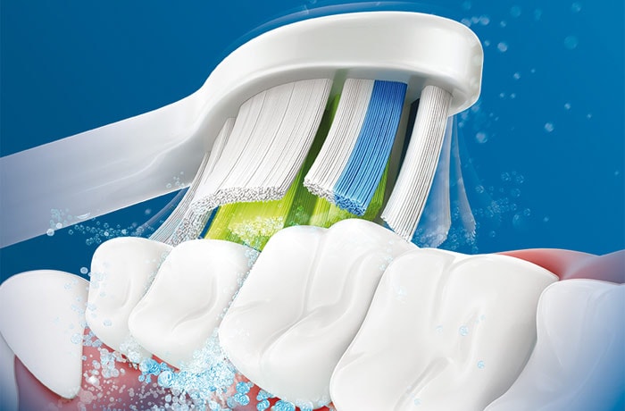 illustrazione di una testina di uno spazzolino da denti con setole sottili che spazzola dei denti bianchi.