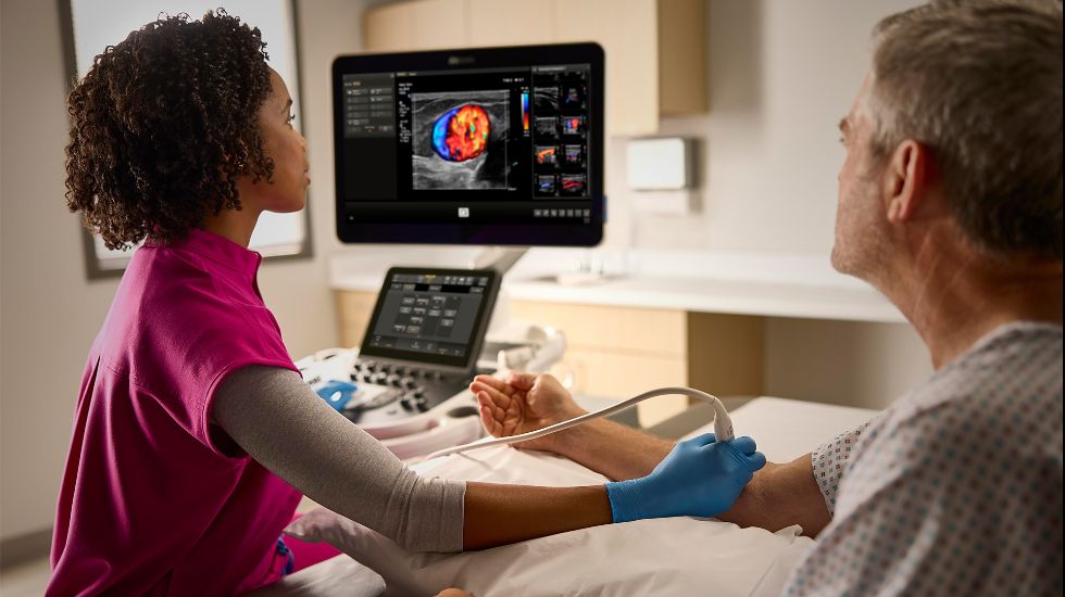 A sonographer performing an ultrasound scan on a patient