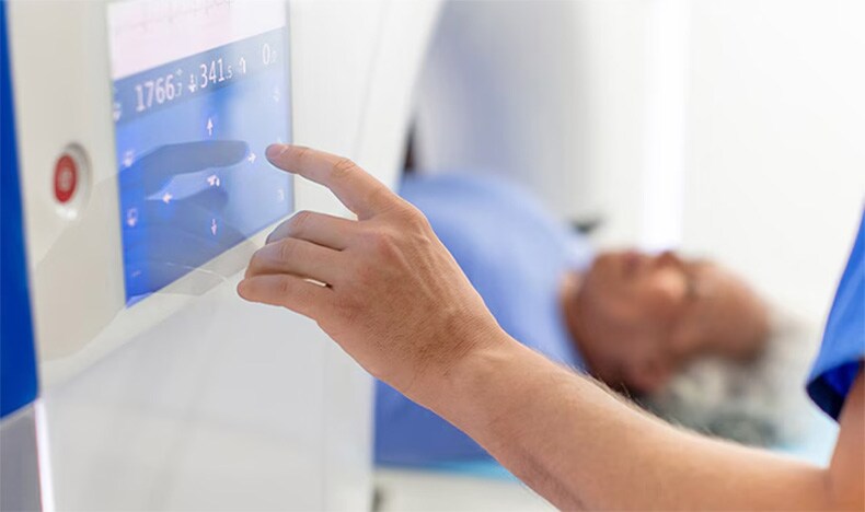 A radiology technician performing a CT scan